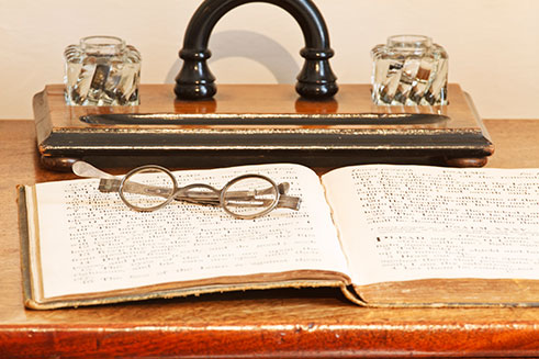 A still-life image of articles on a writing desk in the Brontë Parsonage, West Yorkshire.