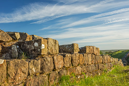 Hadrian’s Wall, Northumberland, on a sunny day with a blue sky. 