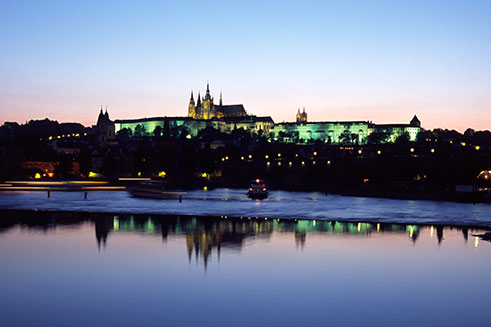 A travel image of Prague Castle, Czech Republic, at dusk, from across the River Vltava. 