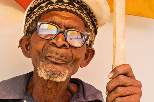 A portrait of an elderly man with a parasol, in Stone Town, Zanzibar. 