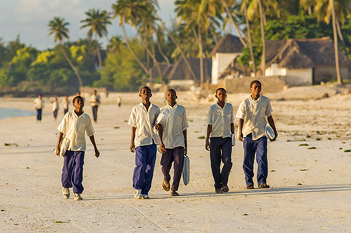Travel photography image of young boys on their way to school in Jambiani, Zanzibar.